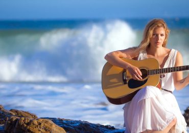 6928404-woman-playing-guitar-coast