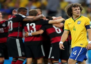Thomas Mueller of Germany celebrates scoring his team's first goal with teammates during the 2014 FIFA World Cup Brazil Semi Final match between Brazil and Germany at Estadio Mineirao on July 8, 2014 in Belo Horizonte, Brazil.