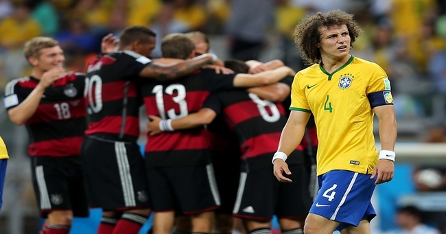 Thomas Mueller of Germany celebrates scoring his team's first goal with teammates during the 2014 FIFA World Cup Brazil Semi Final match between Brazil and Germany at Estadio Mineirao on July 8, 2014 in Belo Horizonte, Brazil.